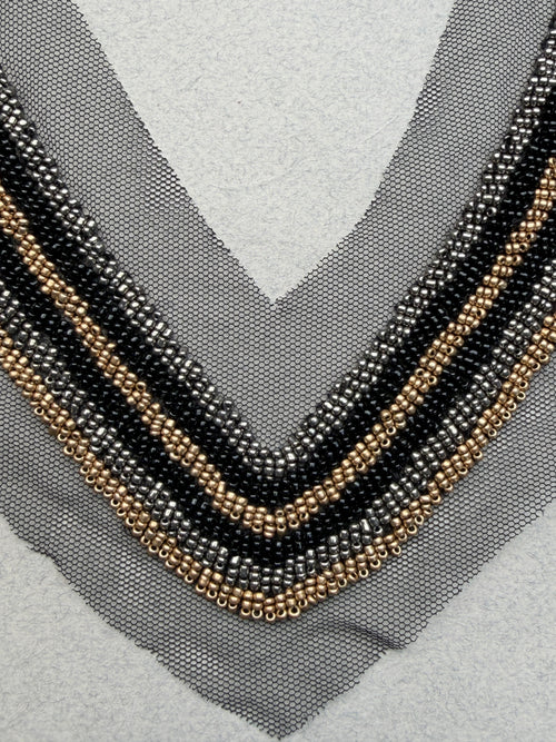 Close up black gold beads sewn on net neckline trim  SP Haberdashery Auckland NZ