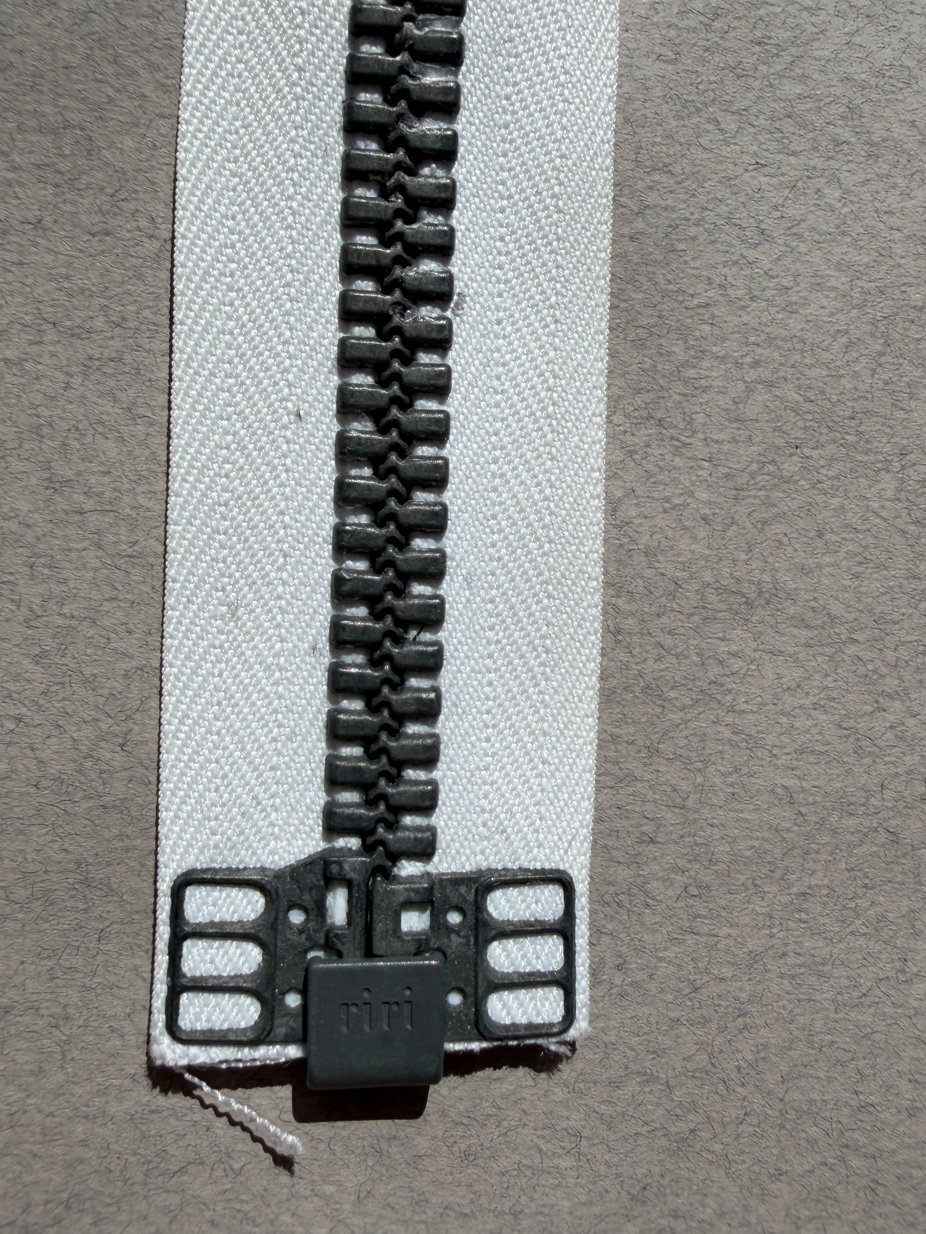 Close up showing end of Riri open end zip white gunmetal SP Haberdashery Auckland NZ