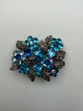 Decorative metal brooch floral motif blue diamantes 40mm