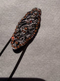 Brooch pin, decorative motif and small stones