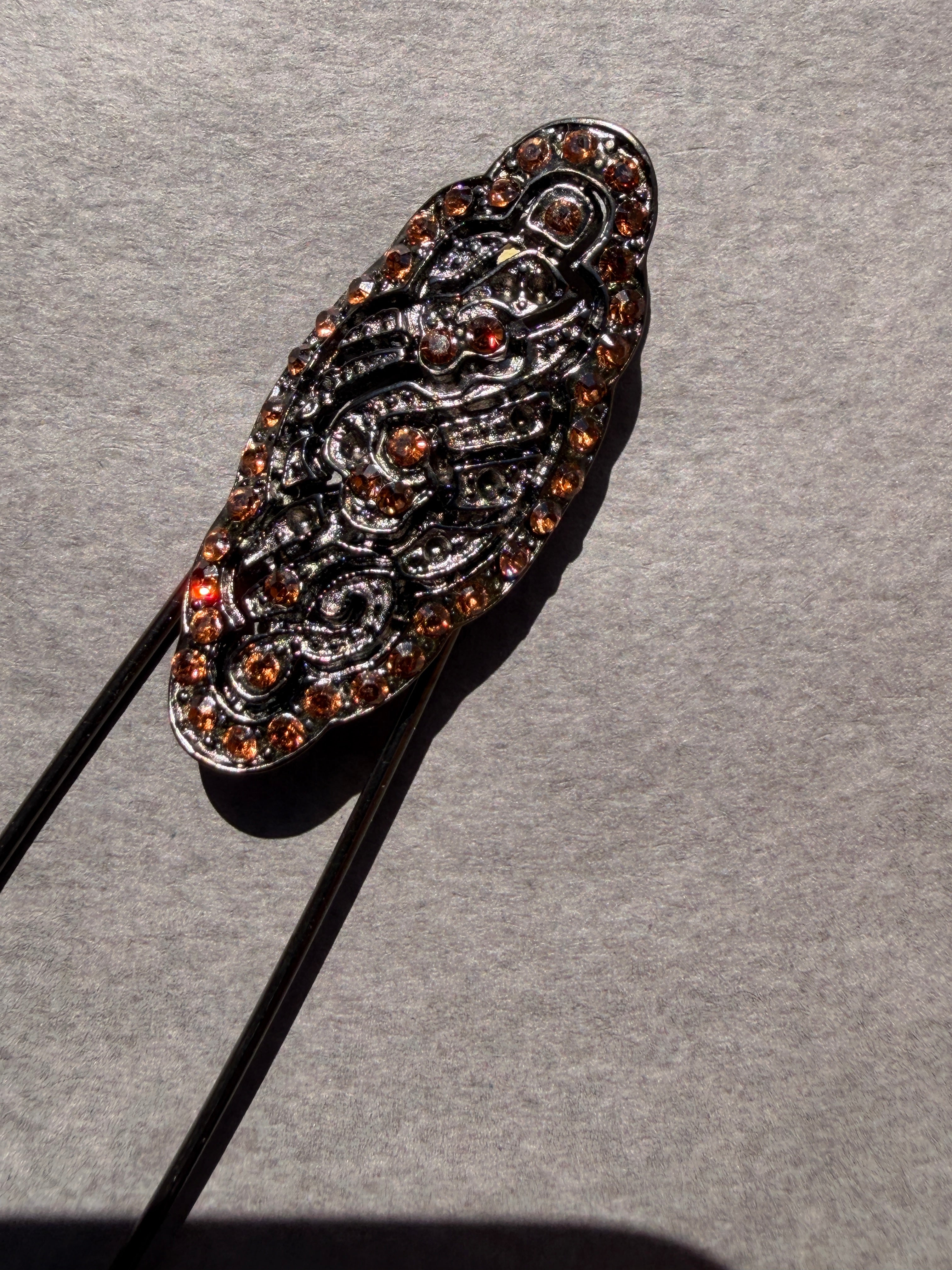 Brooch pin, decorative motif and small stones