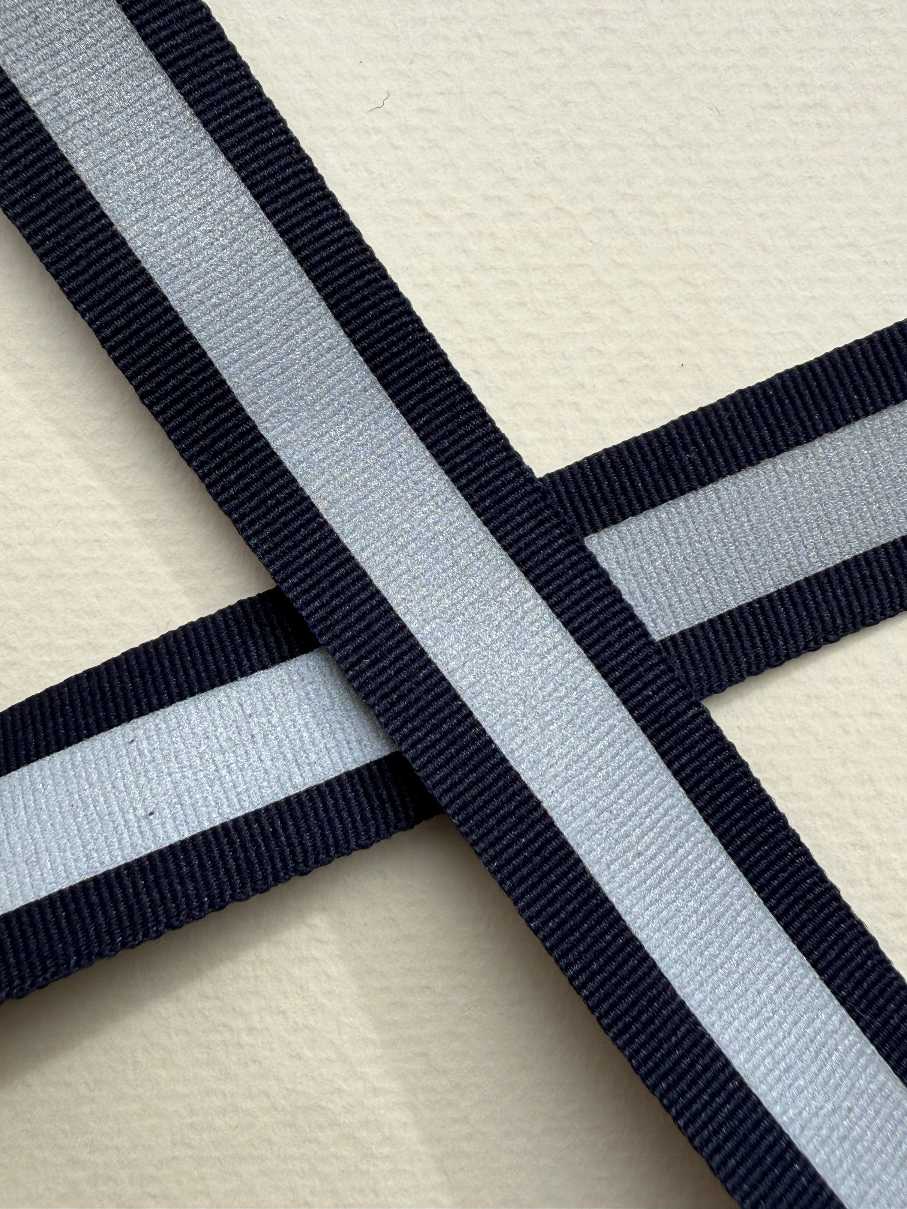 Close up navy woven ribbon with relective centre strip 20mm